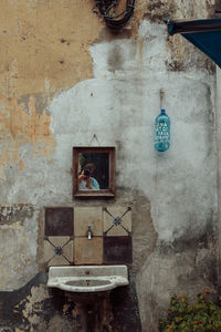 Reflection of person photographing on mirror in abandoned house