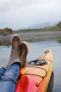 Low section of man on boat at lake