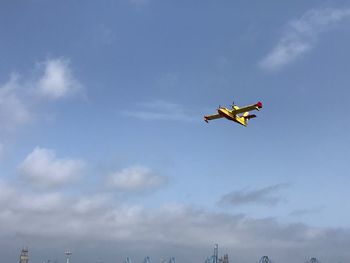 Low angle view of airplane flying in sky