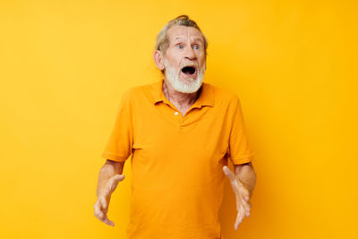 Portrait of woman with face against yellow background