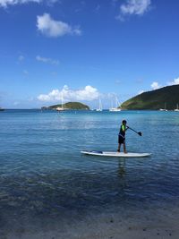 Man in sea against sky