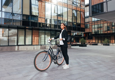 Rear view of man riding bicycle on street