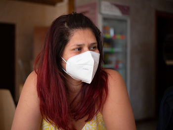 Portrait of young woman wearing mask