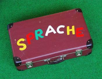 High angle view of colorful text on old-fashioned briefcase over table