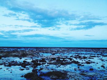 Scenic view of sea against blue sky