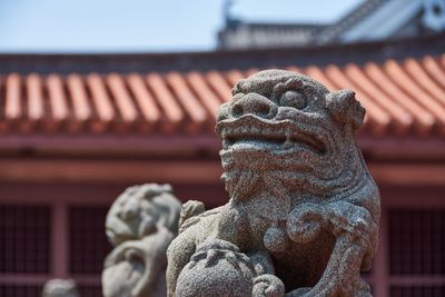 Low angle view of statue against building