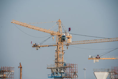 Crane against clear sky building hig bringe in the city