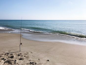 Scenic view of beach against clear sky