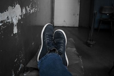 Low section of person wearing canvas shoes