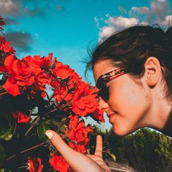 Young woman with red flowers