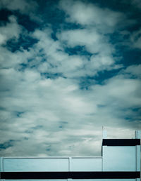 Low angle view of building against cloudy sky