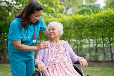 Side view of mother and daughter in park