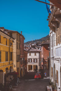 Street amidst buildings in city against sky