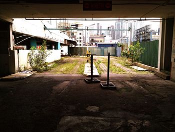 Empty road amidst buildings in city