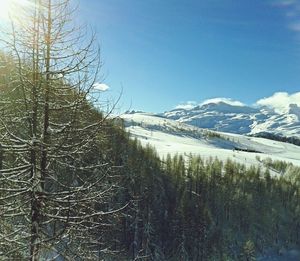 Scenic view of snow covered mountains against sky