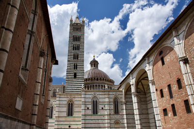 Low angle view of siena cathedral against sky