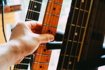 Midsection of man playing guitar