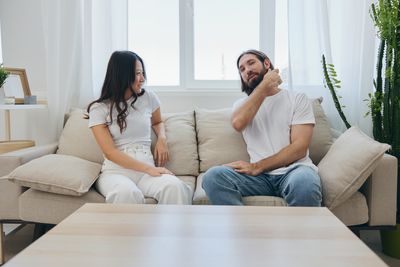 Female friends using laptop at home