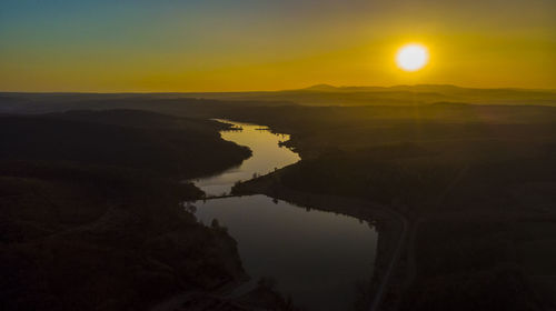 Scenic view of lake against sky during sunset