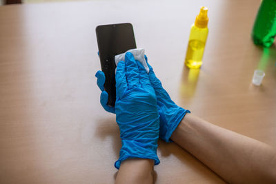 High angle view of person wearing shoes on table