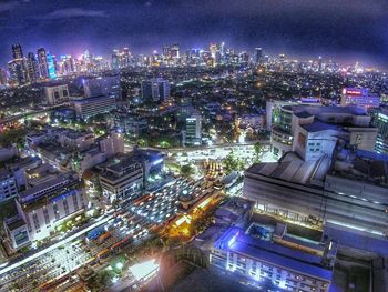 High angle view of illuminated cityscape against sky at night