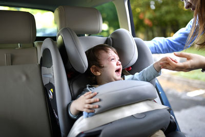 Rear view of woman sitting in car