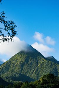 Scenic view of mountains against blue sky