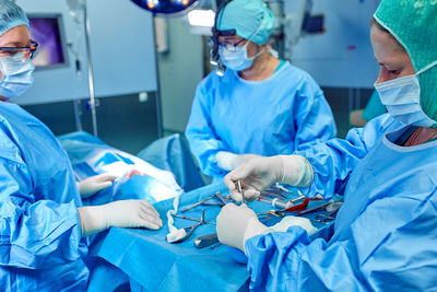 Surgeons performing surgery in hospital