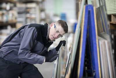 Technician male working in a store checking a glass plate