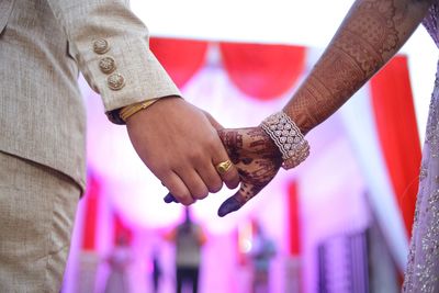 Close-up of couple holding hands