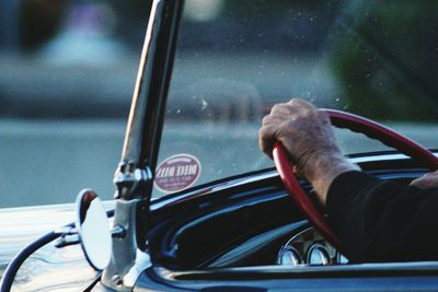 Close-up of man driving car