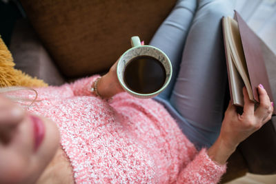 A woman holds a turkish brewed coffee. view from above.