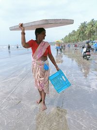 Full length of woman standing on beach