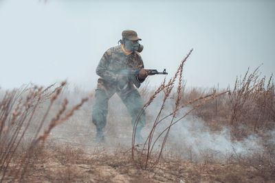 Full length of soldier fighting over snow covered land during winter