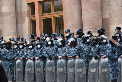 Police in riot gear protecting the government building against protestors