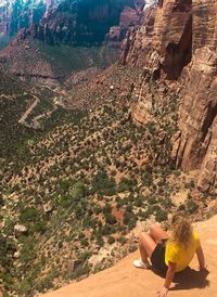 High angle view of people sitting on rock