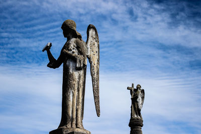 Low angle view of statue against sky