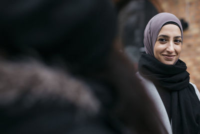 Portrait of young woman wearing headscarf