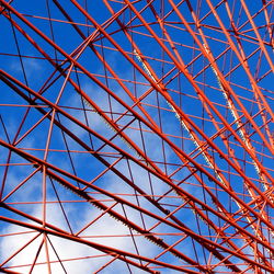 Low angle view of metallic structure against clear blue sky