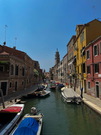 Boats in canal in city