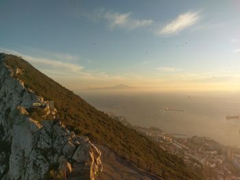 High angle view of city by sea against sky