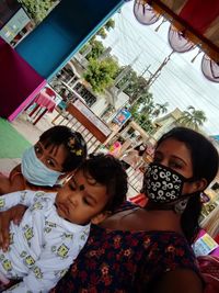 Low angle view of friends standing against the wall