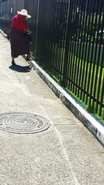 Woman walking on footpath