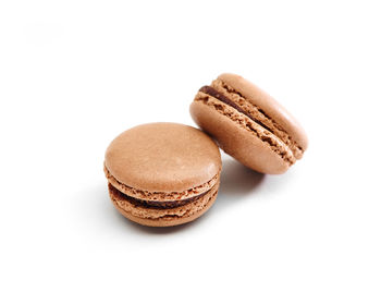 Close-up of macaroons over white background