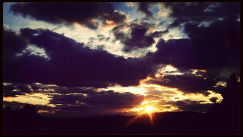 Low angle view of cloudy sky at sunset