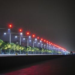 Illuminated bridge against sky in city at night