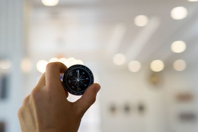 Close-up of hand holding compass