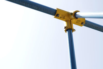 Low angle view of metal against sky