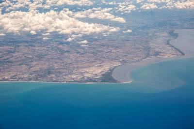 Aerial view of sea and landscape against sky