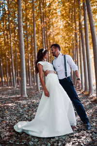 Smiling couple romancing in forest